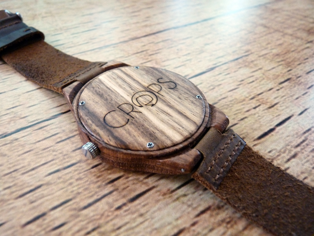 Wooden watch with engraved message, advertising agency